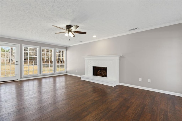 unfurnished living room featuring visible vents, a healthy amount of sunlight, and wood finished floors