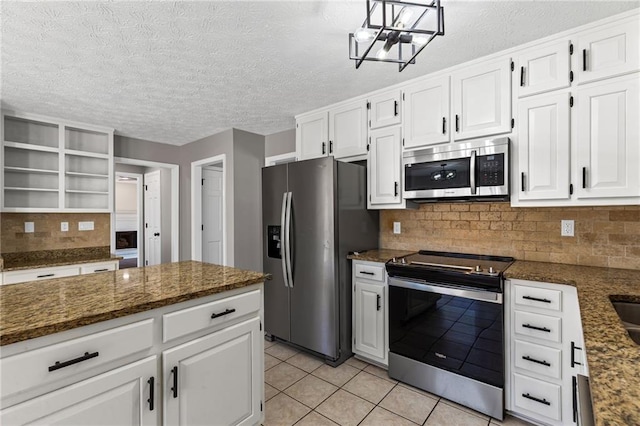 kitchen featuring decorative backsplash, open shelves, white cabinets, and appliances with stainless steel finishes