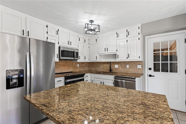 kitchen featuring white cabinets, appliances with stainless steel finishes, and a sink