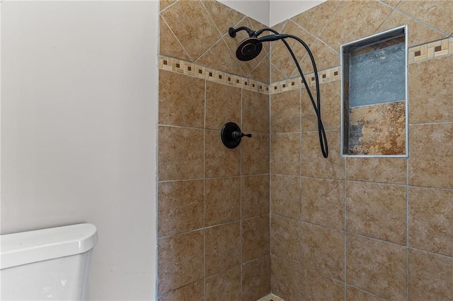 bathroom featuring toilet and tiled shower