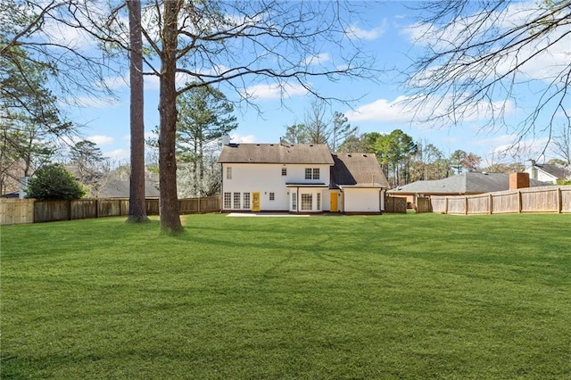 back of property featuring a yard and a fenced backyard