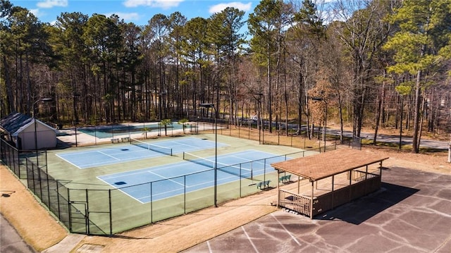 view of tennis court with fence