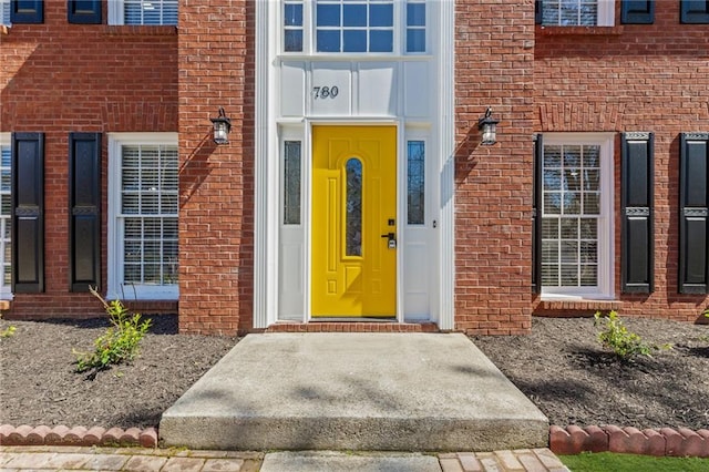 property entrance with brick siding