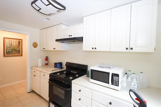 236 Hiram Sudie Rd, Dallas, GA 30157 - kitchen featuring white microwave, black gas range, under cabinet range hood, light countertops, and white cabinets