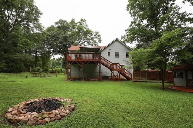 236 Hiram Sudie Rd, Dallas, GA 30157 - rear view of property with stairs, a wooden deck, a fire pit, central AC, and an outbuilding