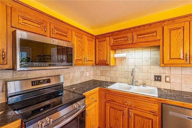 kitchen featuring tasteful backsplash, appliances with stainless steel finishes, and sink