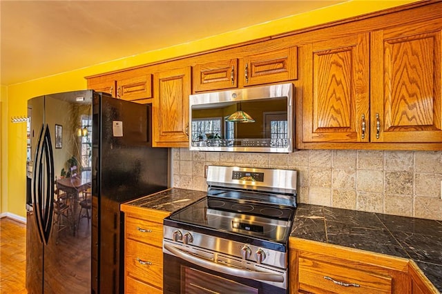 kitchen featuring appliances with stainless steel finishes and backsplash