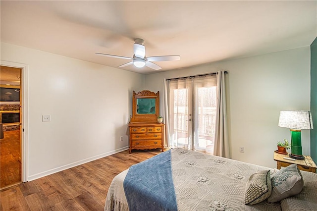 bedroom with hardwood / wood-style flooring, access to exterior, and ceiling fan