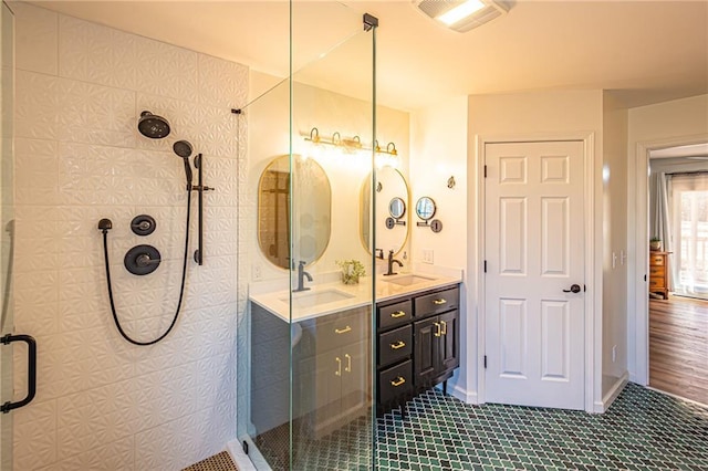 bathroom with vanity and a shower with door