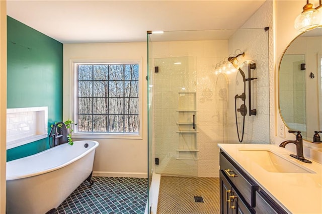 bathroom featuring independent shower and bath, vanity, and a wealth of natural light