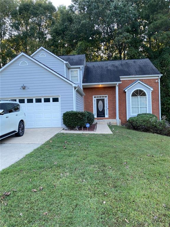 view of front of property with a front yard and a garage