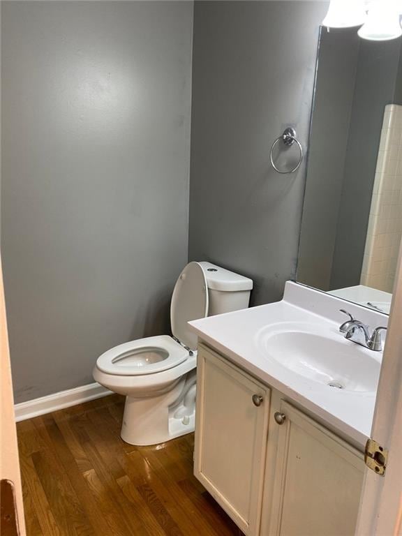 bathroom featuring vanity, hardwood / wood-style flooring, and toilet