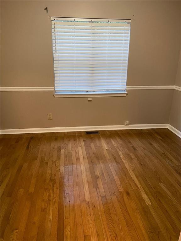 unfurnished room with hardwood / wood-style flooring