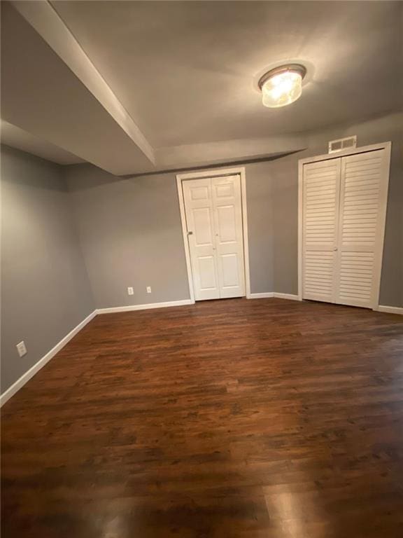 unfurnished bedroom featuring dark wood-type flooring