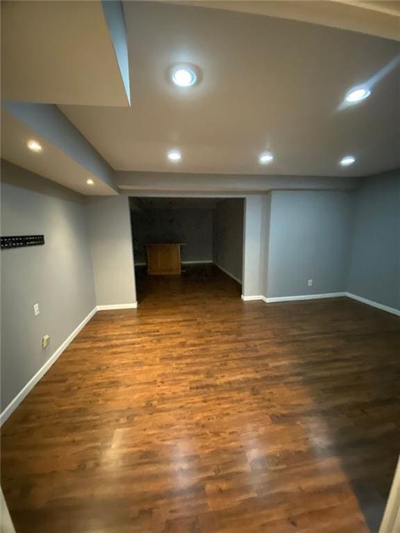 basement with dark hardwood / wood-style flooring