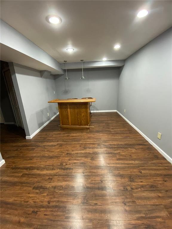 bar featuring dark hardwood / wood-style floors