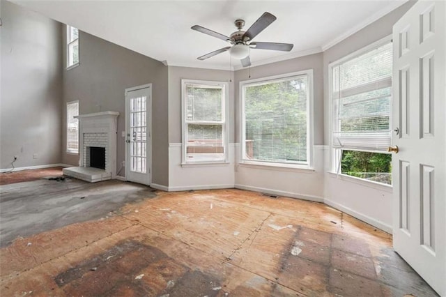 4467 Boatmans Cv, Stone Mountain, GA 30083 - unfurnished living room featuring healthy amount of natural light, a fireplace, ornamental molding, and ceiling fan