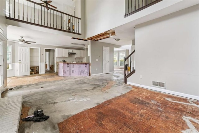 4467 Boatmans Cv, Stone Mountain, GA 30083 - unfurnished living room featuring a ceiling fan, a high ceiling, and stairs