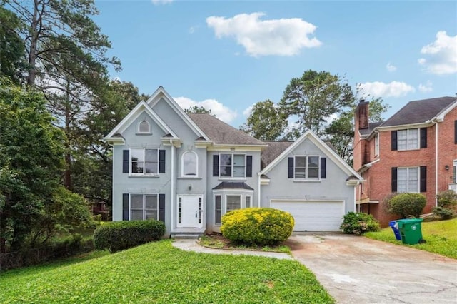 4467 Boatmans Cv, Stone Mountain, GA 30083 - view of front facade featuring driveway, stucco siding, an attached garage, and a front yard