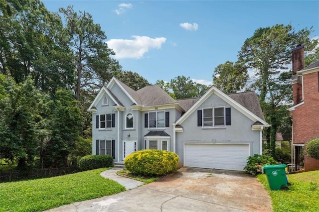 4467 Boatmans Cv, Stone Mountain, GA 30083 - view of front facade with stucco siding, concrete driveway, an attached garage, and a front yard
