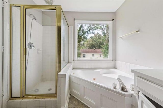 4467 Boatmans Cv, Stone Mountain, GA 30083 - bathroom featuring a stall shower, a tub with jets, plenty of natural light, and vanity