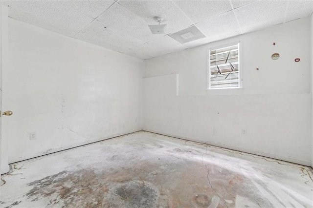 4467 Boatmans Cv, Stone Mountain, GA 30083 - empty room with unfinished concrete flooring and a paneled ceiling