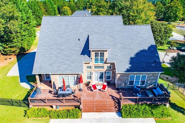 view of front facade with a deck and a front lawn