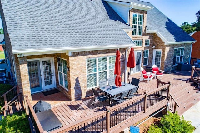 back of house with a wooden deck and french doors