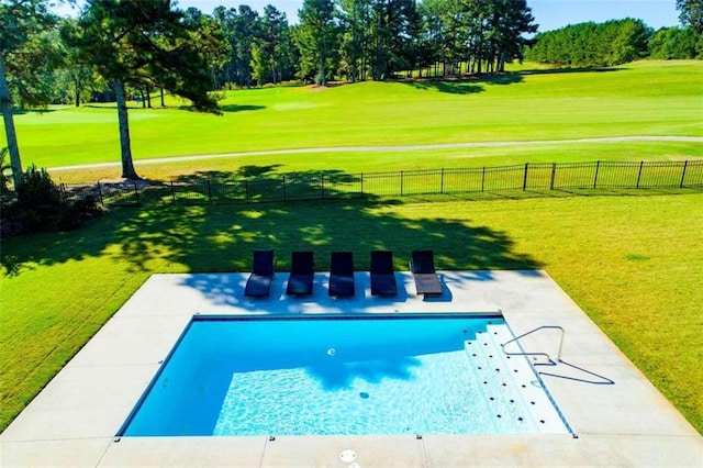 view of swimming pool with a patio and a yard