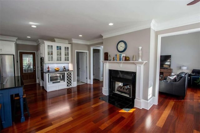 living room with crown molding and dark hardwood / wood-style flooring