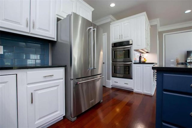 kitchen featuring appliances with stainless steel finishes, white cabinetry, crown molding, and dark wood-type flooring