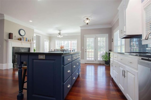 kitchen with dark hardwood / wood-style floors, white cabinetry, backsplash, and blue cabinetry