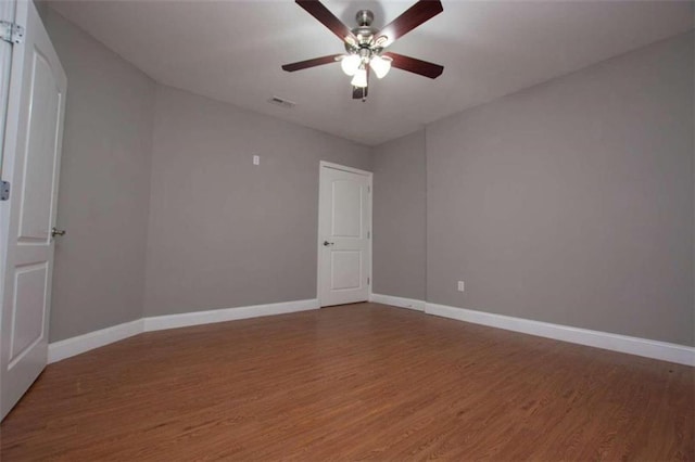 empty room featuring wood-type flooring and ceiling fan