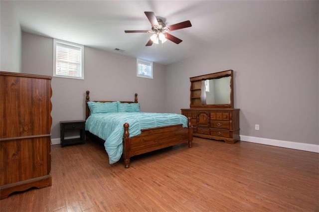 bedroom featuring light hardwood / wood-style flooring, multiple windows, and ceiling fan