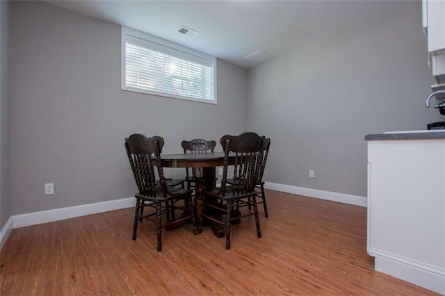 dining space with light hardwood / wood-style floors