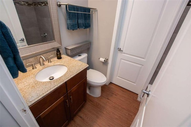 bathroom featuring hardwood / wood-style flooring, toilet, and vanity