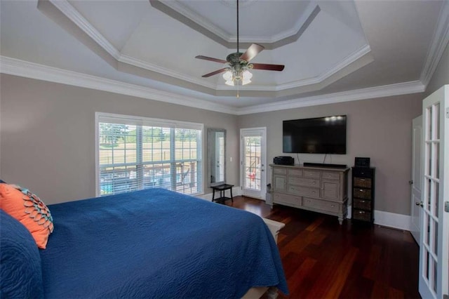 bedroom featuring ceiling fan, dark hardwood / wood-style flooring, a raised ceiling, and ornamental molding