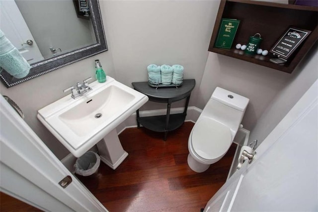 bathroom with toilet and wood-type flooring