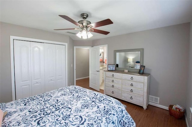 bedroom with dark hardwood / wood-style flooring, a closet, and ceiling fan