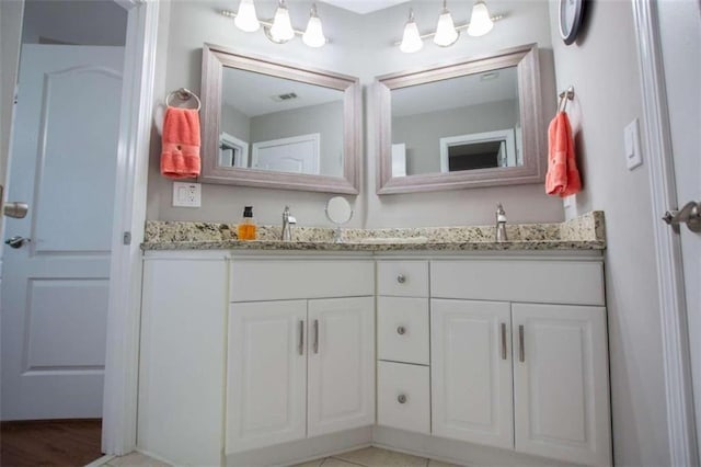 bathroom featuring dual vanity and hardwood / wood-style flooring