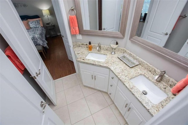 bathroom with tile patterned flooring and dual bowl vanity