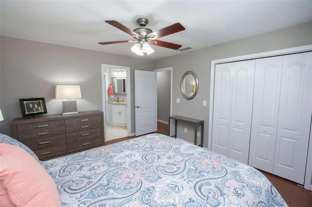 bedroom with ensuite bath, ceiling fan, light wood-type flooring, and a closet