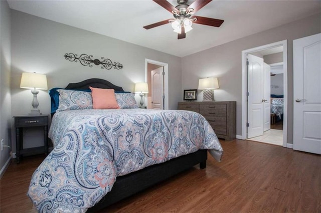 bedroom featuring ceiling fan, connected bathroom, and hardwood / wood-style floors