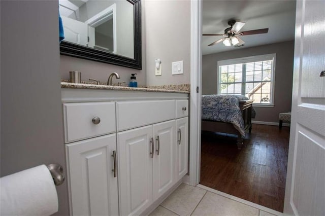 bathroom with hardwood / wood-style floors, vanity, and ceiling fan