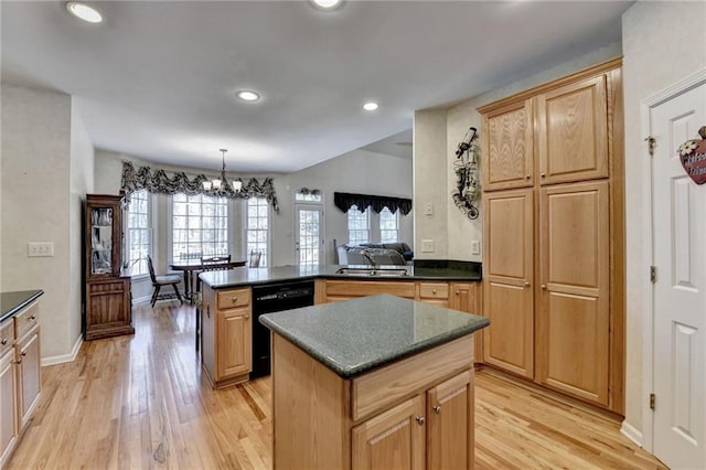 kitchen featuring a peninsula, an inviting chandelier, light wood-style floors, dishwasher, and dark countertops