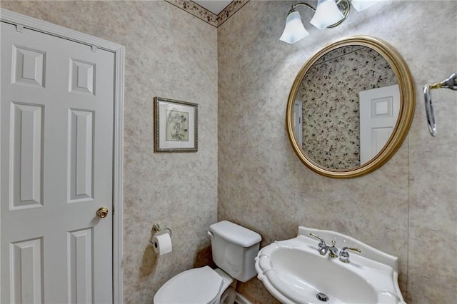 bathroom featuring toilet and a sink