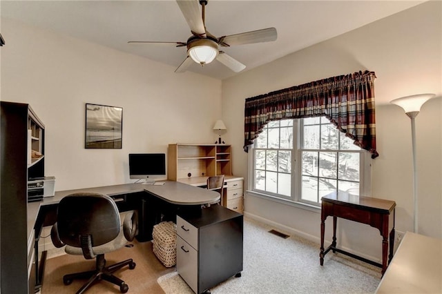 office space featuring visible vents, carpet, baseboards, and ceiling fan