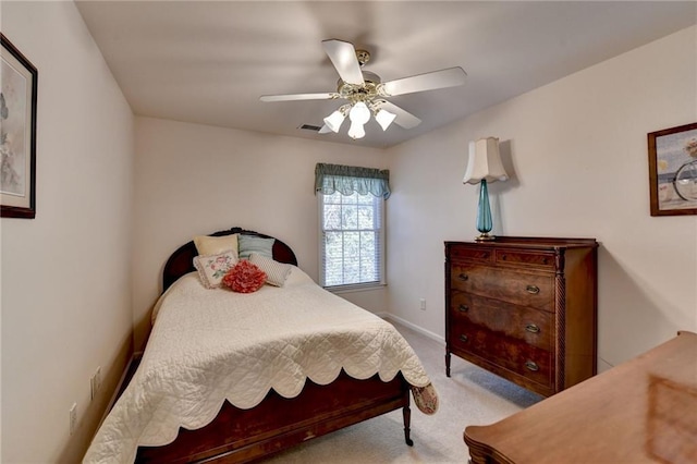 bedroom with visible vents, baseboards, light colored carpet, and a ceiling fan