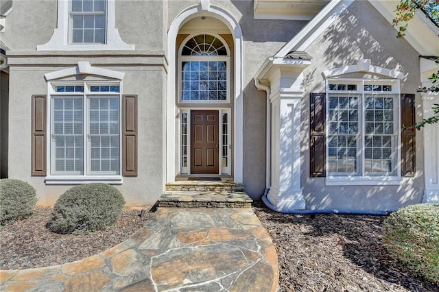 property entrance with stucco siding