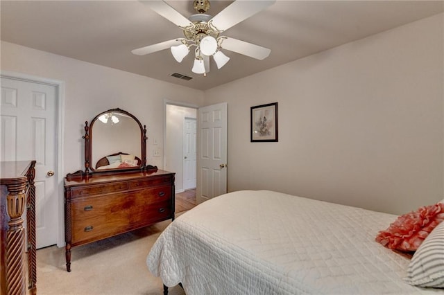 bedroom featuring light carpet, visible vents, and ceiling fan